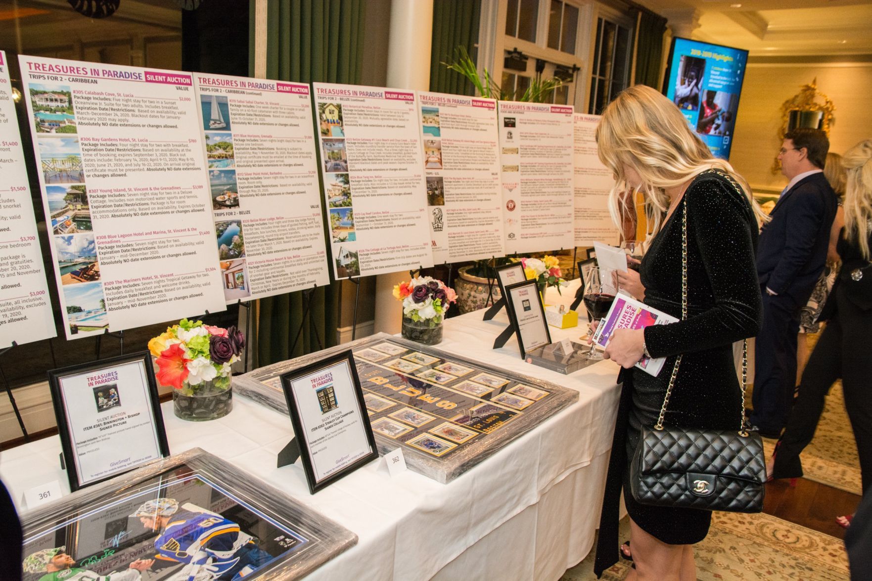 Guests look at the silent auction items